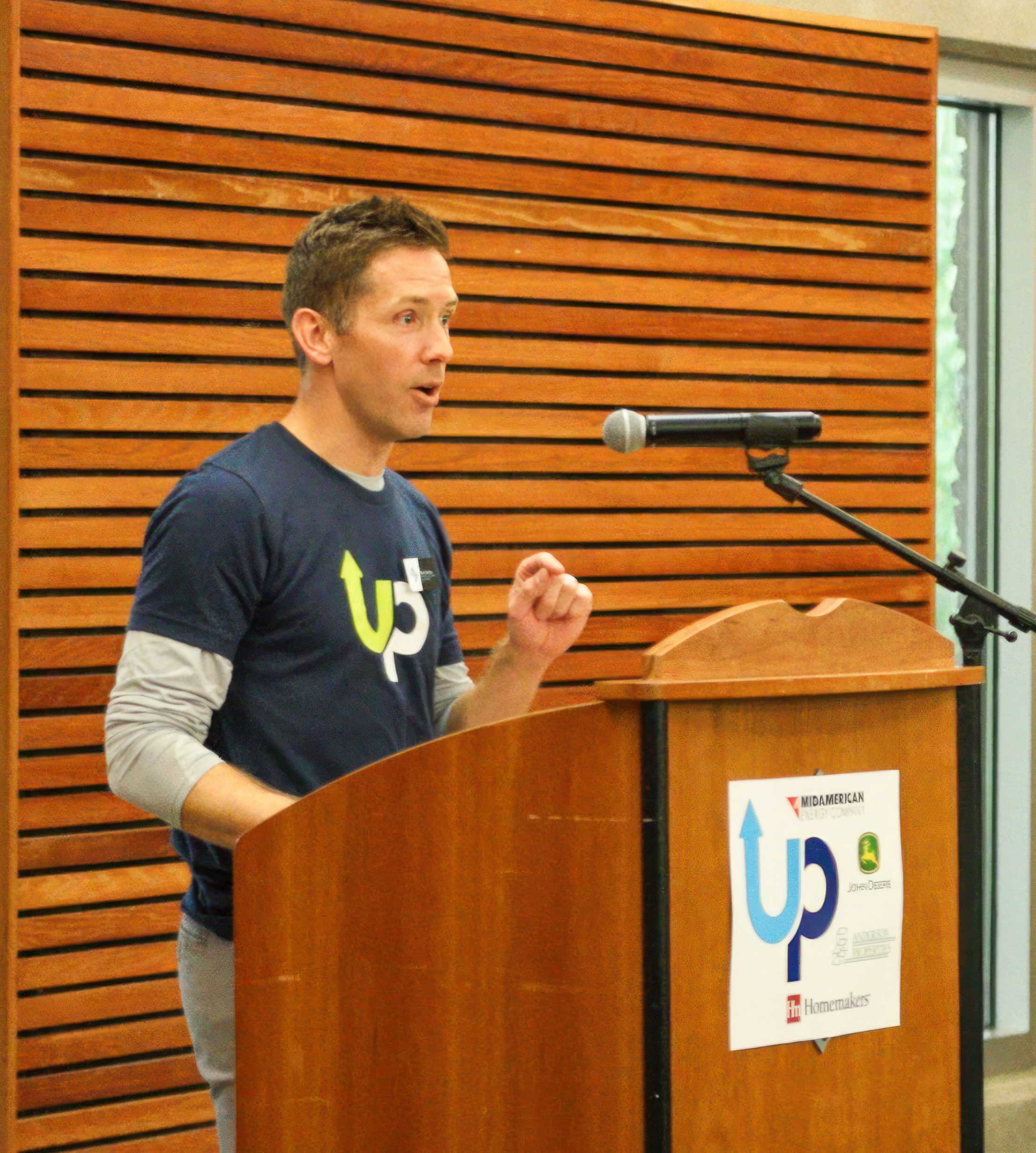 Aaron speaking at a podium