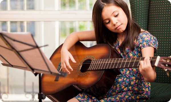 Little Girl Playing the Guitar