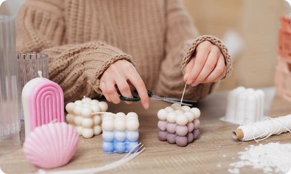Young woman making candles