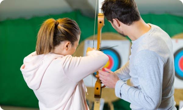 People shooting arrows at targets