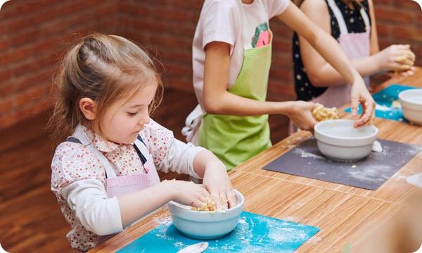 Little Girls Kneading Dough