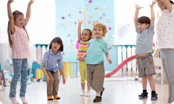 Group of Children moving around in a class