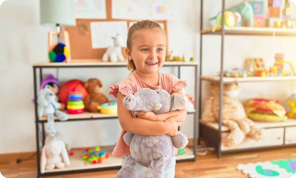 Girl Hugging Cute Stuffed Elephant