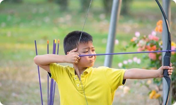 Young boy doing archery