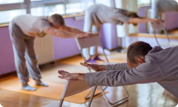 Yoga Class, Downward Facing Dog with the Help of a Chair Done