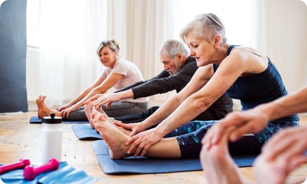 Group of Senior People Doing Exercise in Community Center Club