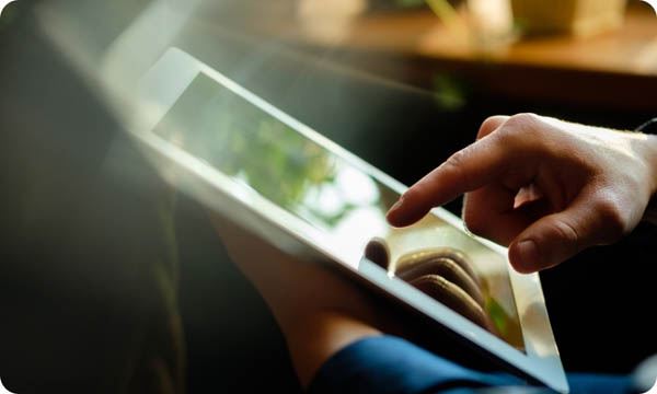 A Man Works in a Tablet with a Natural Light Source
