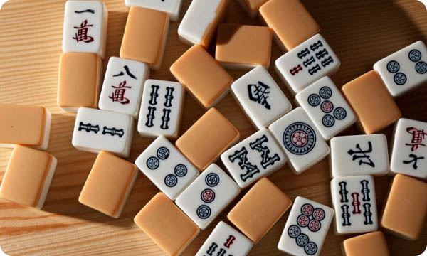 Mahjong Tiles on Wood Table Background