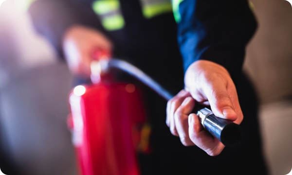  Man Using Fire Extinguisher Fighting Fire Closeup