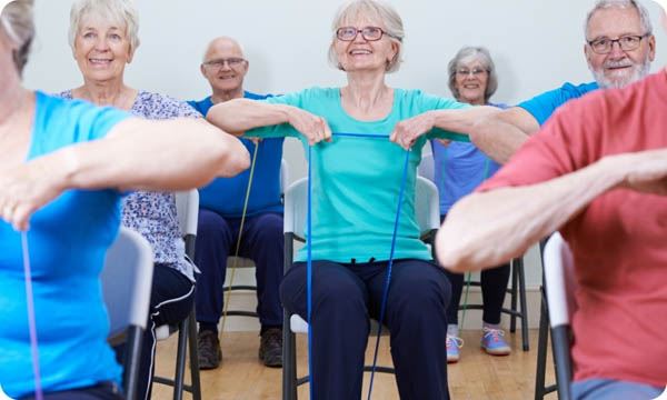 Group of Seniors Using Resistance Bands in Fitness Class