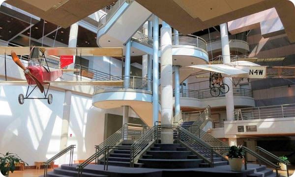 State Historical Building interior showing a large stair case and planes hanging from the ceiling.jpg