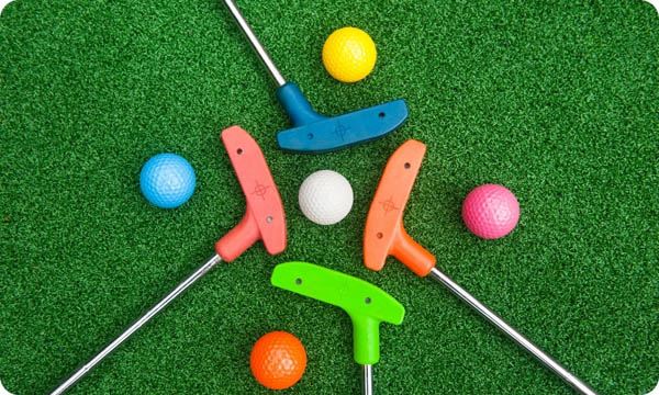 Four Mini Golf Putters with Balls