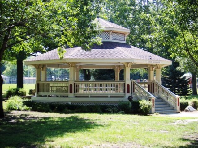 A gazebo in a wooded area of a city park